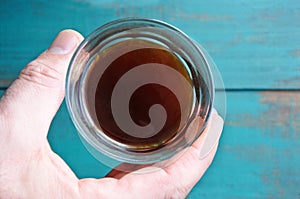 Top view of man hand holds a black coffee cup