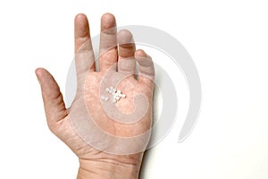 top view man hand with homeopathy balls on white background. flat lay