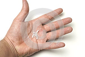 top view man hand with homeopathy balls on white background. flat lay flat