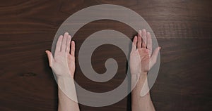 Top view man hands offer gesture black walnut table with copy space