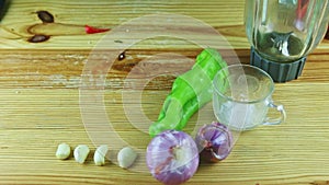 Top view on man by hands put red paprika slices into glass blender chalice