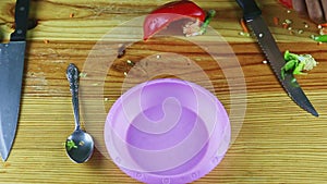 Top view on man hands puts small plastic plate next to different leftovers on table