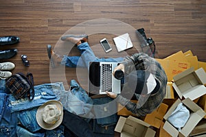 Top view of man holding coffee cup working laptop computer