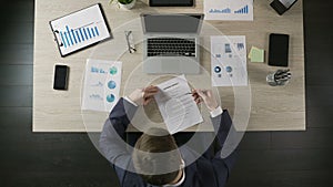 Top view of man signing business contract, concluding agreement with partner