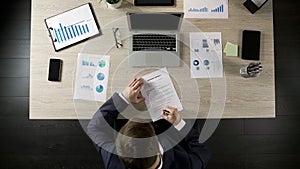 Top view of man signing business contract, concluding agreement with partner