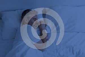 Top view of man sleeping alone in bed at night