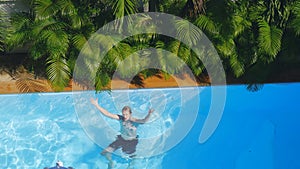 Top of view of man swimming in outdoor pool