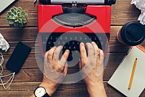 Top view of man using typewriter