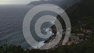 Top view of Manarola town lying on cliff rocks, coastline, travel to Italy