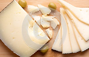 Top view of manchego cheese on wooden board