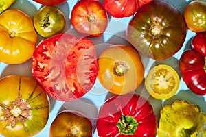 Top view of many delicious fresh tomatoes of different sort. Summer taste. Garden, domestic products. Full and sliced