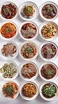 Top view of many plates on dinner dishes from different dishes covered in sauce on white background