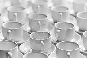 Top view on many stacked in rows of empty clean white cups for tea or coffee. Close-up. Background.