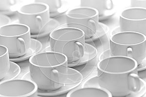 Top view on many stacked in rows of empty clean white cups for tea or coffee. Close-up. Background.