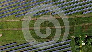 Top view on the massive solar power station with long rows of solar panels, 4k