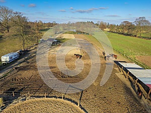Top view of a meadow with horses and stables, Freewheeling horse