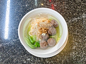 top view of meatballs with noodle soup in bowl