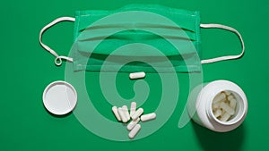 Top view of medical facial mask,medical pills,medical capsules,vitamins for maintaining health,closeup