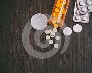 Top view of medicine Pills and tablets with orange pill bottle for healthcare.