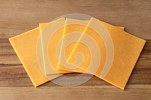 Cheddar Cheese Slices on a Cutting Board