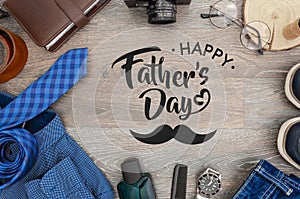 Top view men`s accessories and clothes concept. Card with sign greeting text happy father`s day