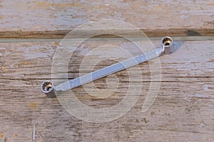 Top view of  metal socket wrench on wooden background. worktool for maintenance and repair photo