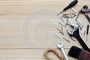 top view of metallic tools and different construction tools on wooden table.