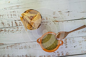 Top view of mexican salsa verde with tortilla chips photo