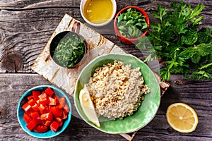 Top view of Middle eastern or arab dishes, set of ingredients of the classic Tabbouleh recipe, Traditional oriental salad Tabouleh