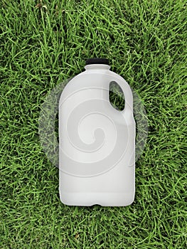 Top view of milk bottle on the grass