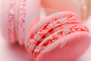 Top view of mini pink and white macaron on soft sweet pink paper