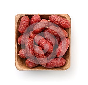 Top view of mini smoked sausages in wooden bowl