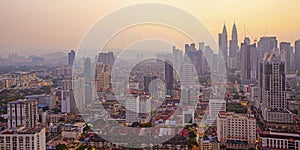 Top view of misty Kuala Lumpur city skyline with Petronas twin towers shot in the morning at sunrise