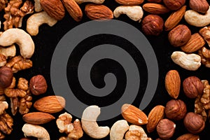 Mix of nuts frame on a black table