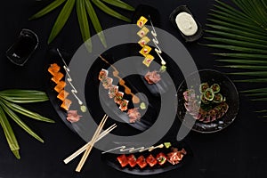 Top view mix of sushi, Japanese food over black table