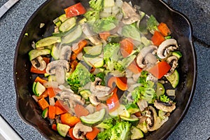 Top view of mixed vegetable stir fry cooking on stove