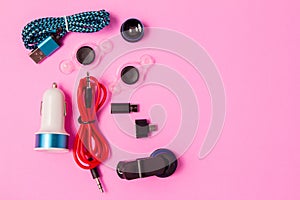 Top view mobile device with mobile blank space for text,.accessories. micro USB Adapter, macro lens on pink background