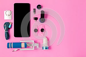 Top view mobile device with mobile blank space for text,.accessories. micro USB Adapter, macro lens on pink background