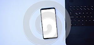 Top view of mobile phone with blank screen for text on white background photo