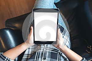 Top view mockup image of a woman sitting cross legged and holding black tablet pc
