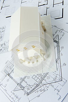 Top view of model of the house printed on a 3D printer with white filament by FDM technology.