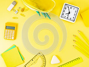 Top view of modern bright yellow office desktop with school supp