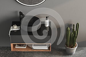 Top view of modern dark bathroom with gray walls, concrete floor and comfortable basin with black faucet,