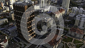 Top view of modern design of building on background of city. Stock footage. Modern city with beautiful architecture and