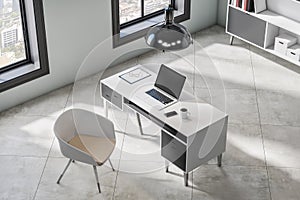 Top view of modern office interior with empty mock up laptop, window and city view, desktop workplace and bookcase. 3D Rendering
