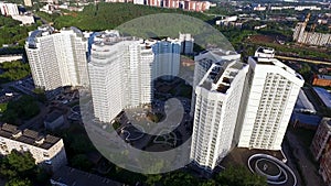 Top view of a modern residential complex with high beautiful houses. Clip. A large window in an apartment building. Many