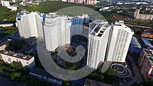 Top view of a modern residential complex with high beautiful houses. Clip. A large window in an apartment building. Many