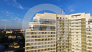 Top view of a modern residential complex with high beautiful houses. Clip. A large window in an apartment building. Many