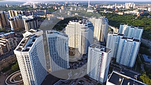 Top view of a modern residential complex with high beautiful houses. Clip. A large window in an apartment building. Many