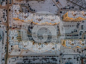 Top view of modern residential houses covered with snow